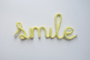 Smile wire word sign wall art
